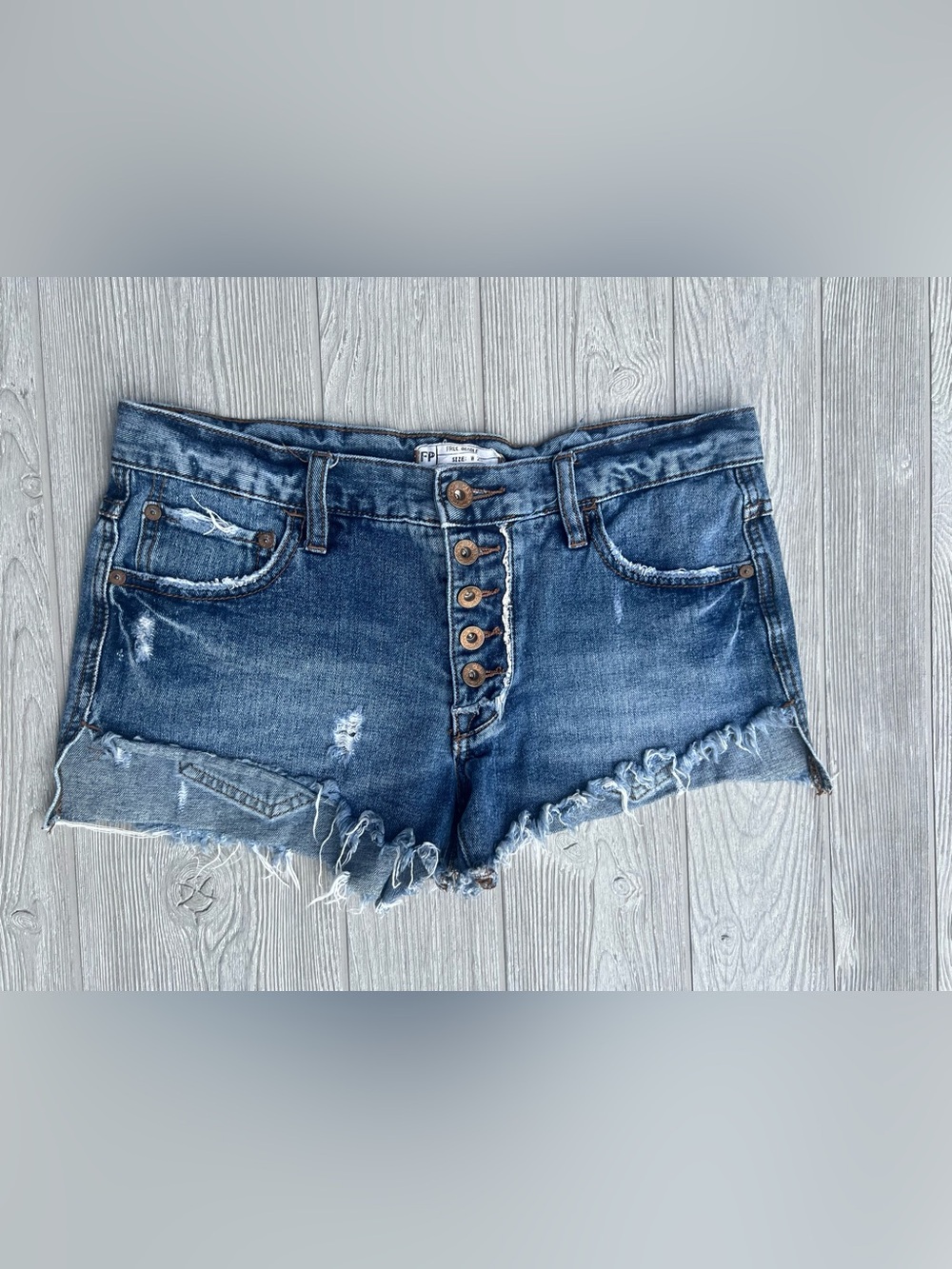 Free People distressed denim cutoff shorts button-fly front Medium Wash Size 25